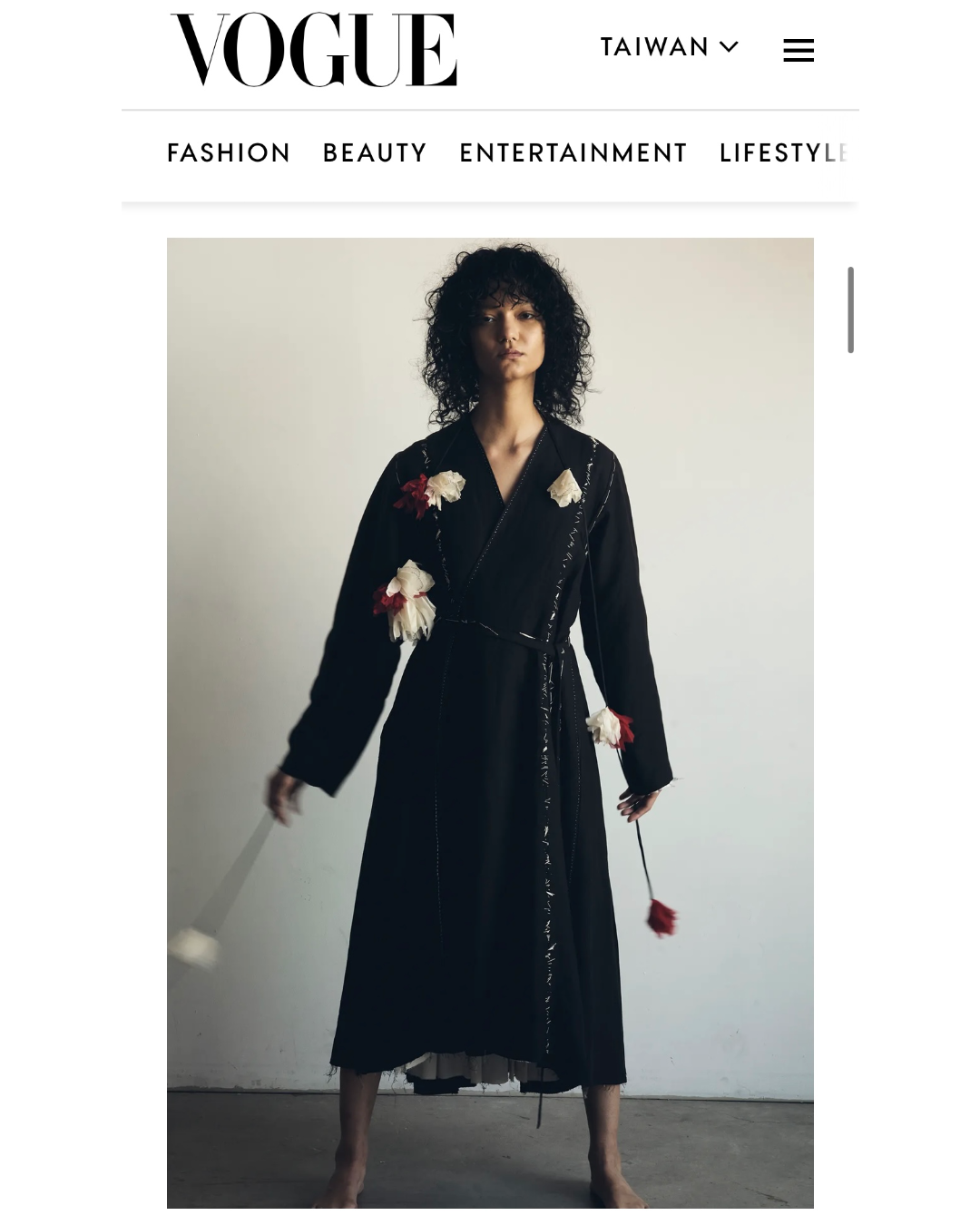A model wearing a black long-sleeve kimono wrap-style dress with ume red/yuki white falling flowers from Considered Objects, Vogue Taiwan