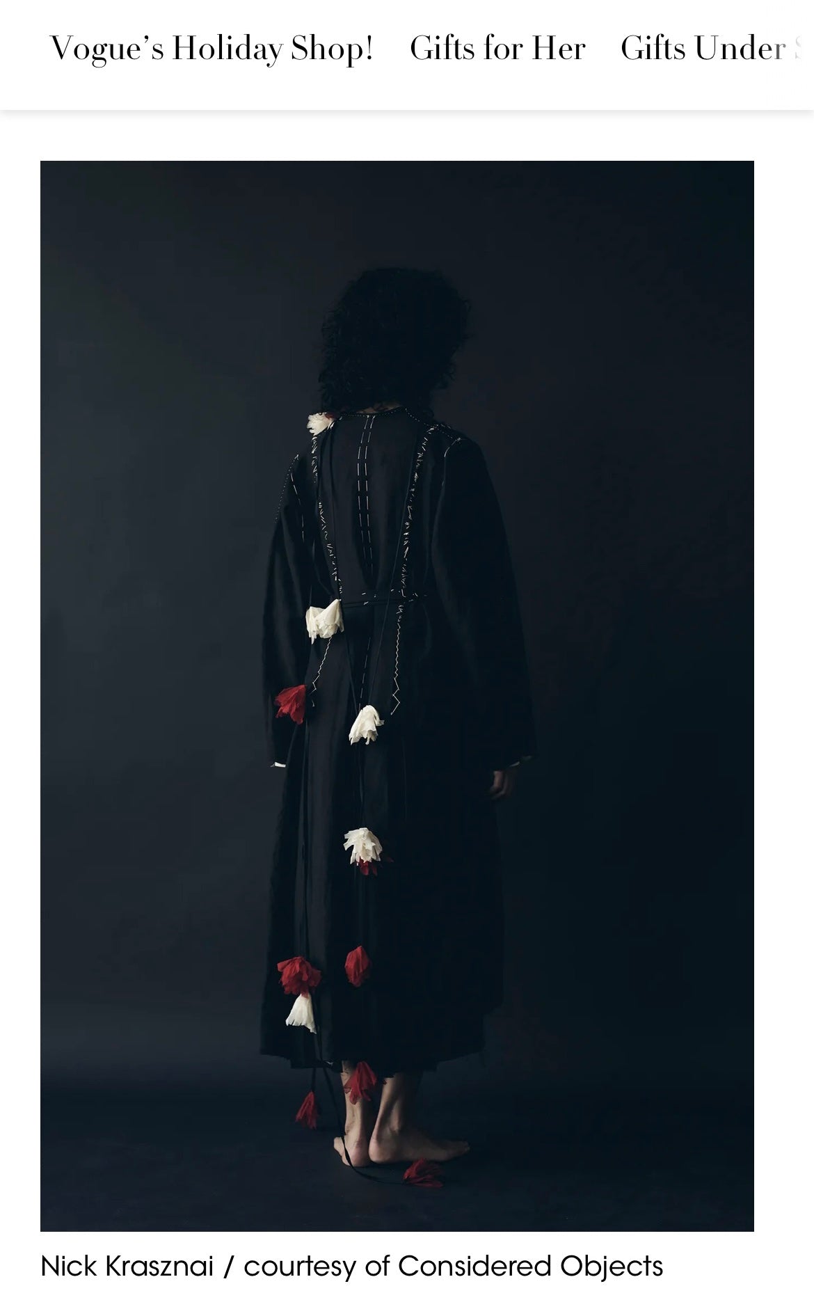 A model shown from the back wearing the irregular wrap dress and ume red/yuki white falling flowers from Considered Objects, featured in Vogue.com
