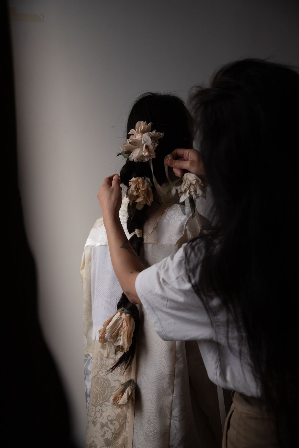 Person adjusting the Falling Flower Accessory on a model.  